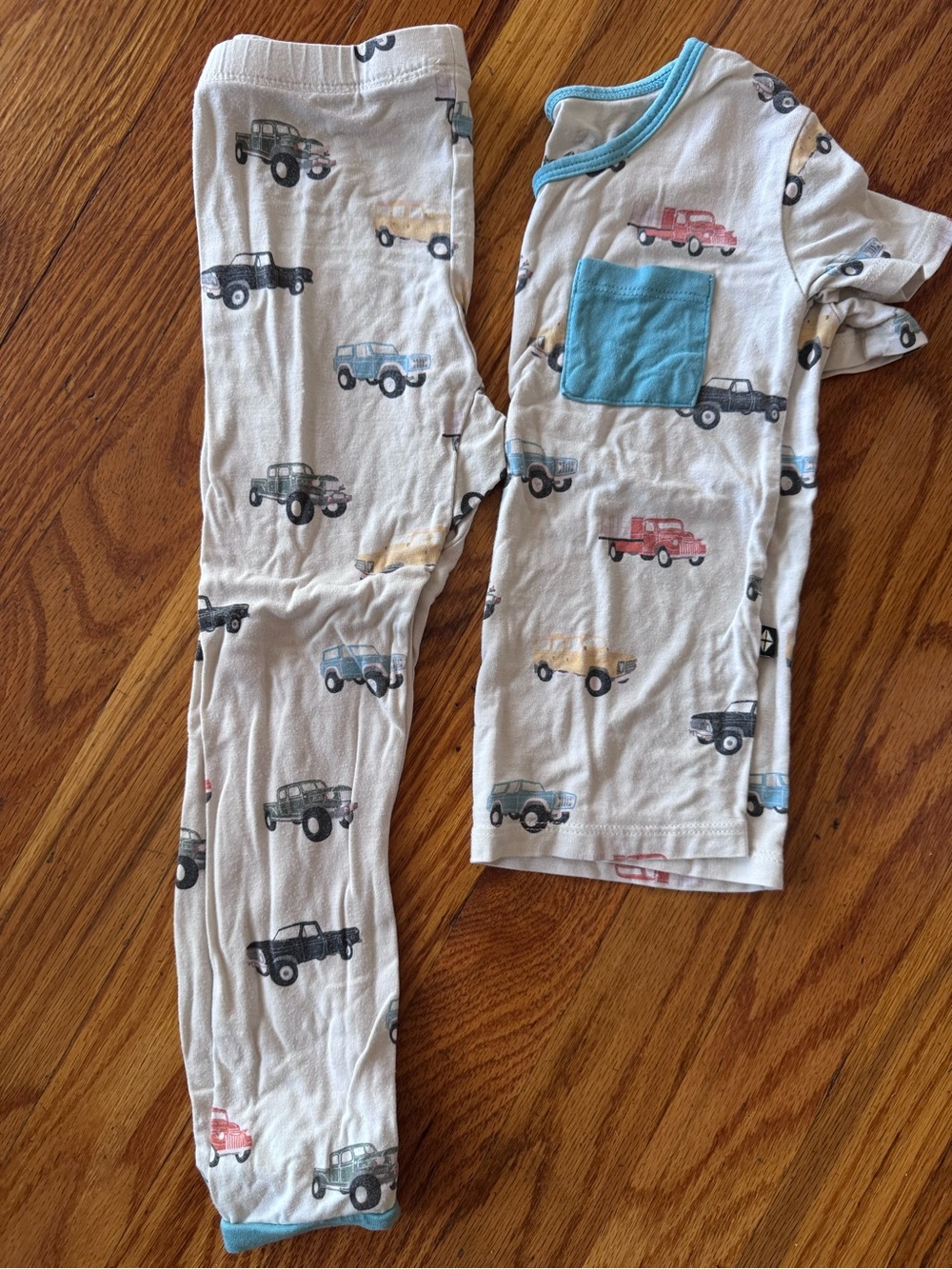 Kyte BABY Cream Pajama Set with Blue Pocket and Multicolor Truck Prints